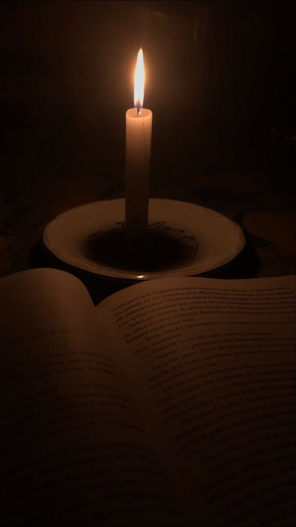 Open book by candlelight in the dark